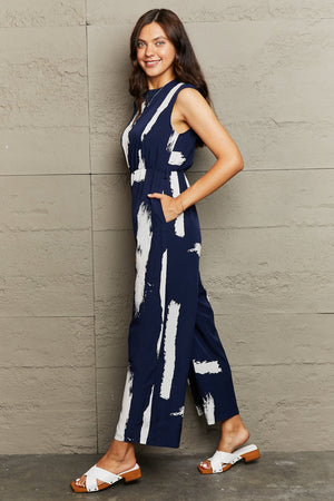 PRINTED ROUND NECK CUTOUT JUMPSUIT WITH POCKETS - Evolve Elegance Boutique